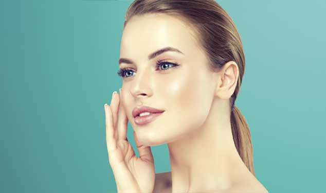 Sofwave ultrasound skin lifting Amsterdam - woman in profile touching her cheek with one Woman in profile touching her cheek with one hand against a teal background for Sofwave ultrasound skin lifting in Amsterdam